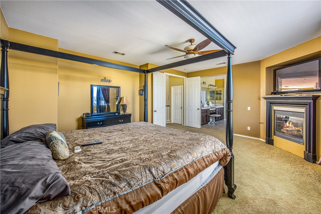 18936 Malkoha Street Perris, CA 92570 - Photo 45 of 70 a bedroom with a bed dresser and a flat tv screen