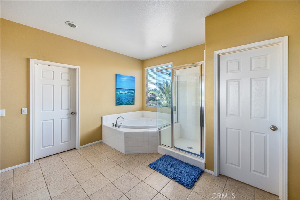 18936 Malkoha Street Perris, CA 92570 - Photo 47 of 70 a spacious bathroom with a tub and shower