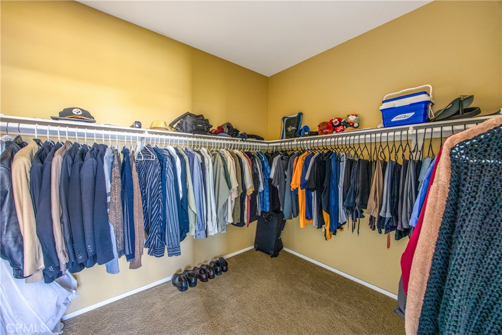 18936 Malkoha Street Perris, CA 92570 - Photo 49 of 70 a view of walk in closet with clothes and shoes