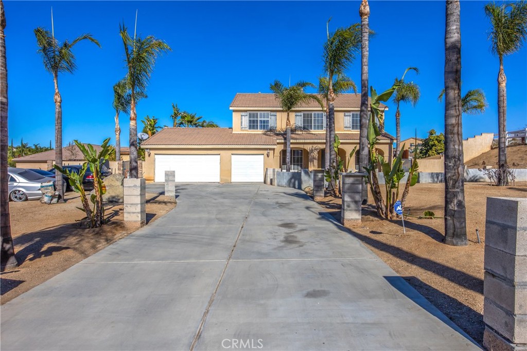 18936 Malkoha Street Perris, CA 92570 - Photo 7 of 70 a view of a house with floor to ceiling windows and potted plants