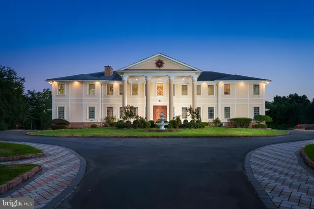 a front view of a house with a yard and trees
