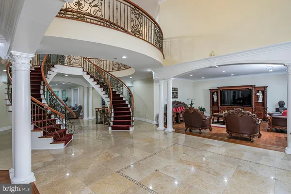 a lobby with furniture and a glass door