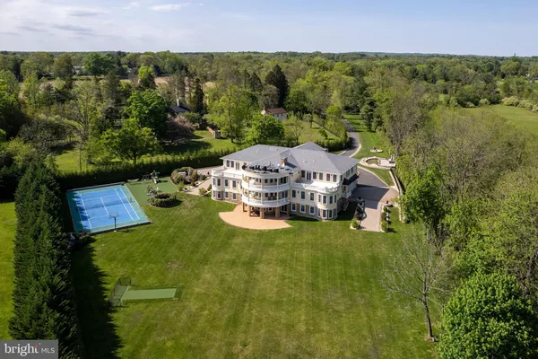 an aerial view of a house with yard swimming pool and outdoor seating