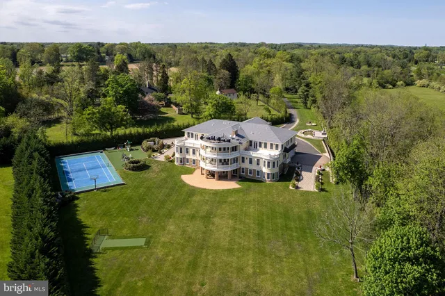 an aerial view of a house with yard swimming pool and outdoor seating