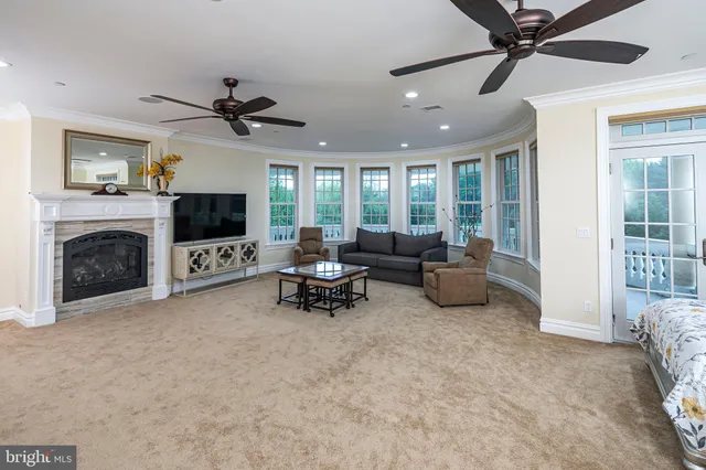 a spacious bedroom with a bed and glass window