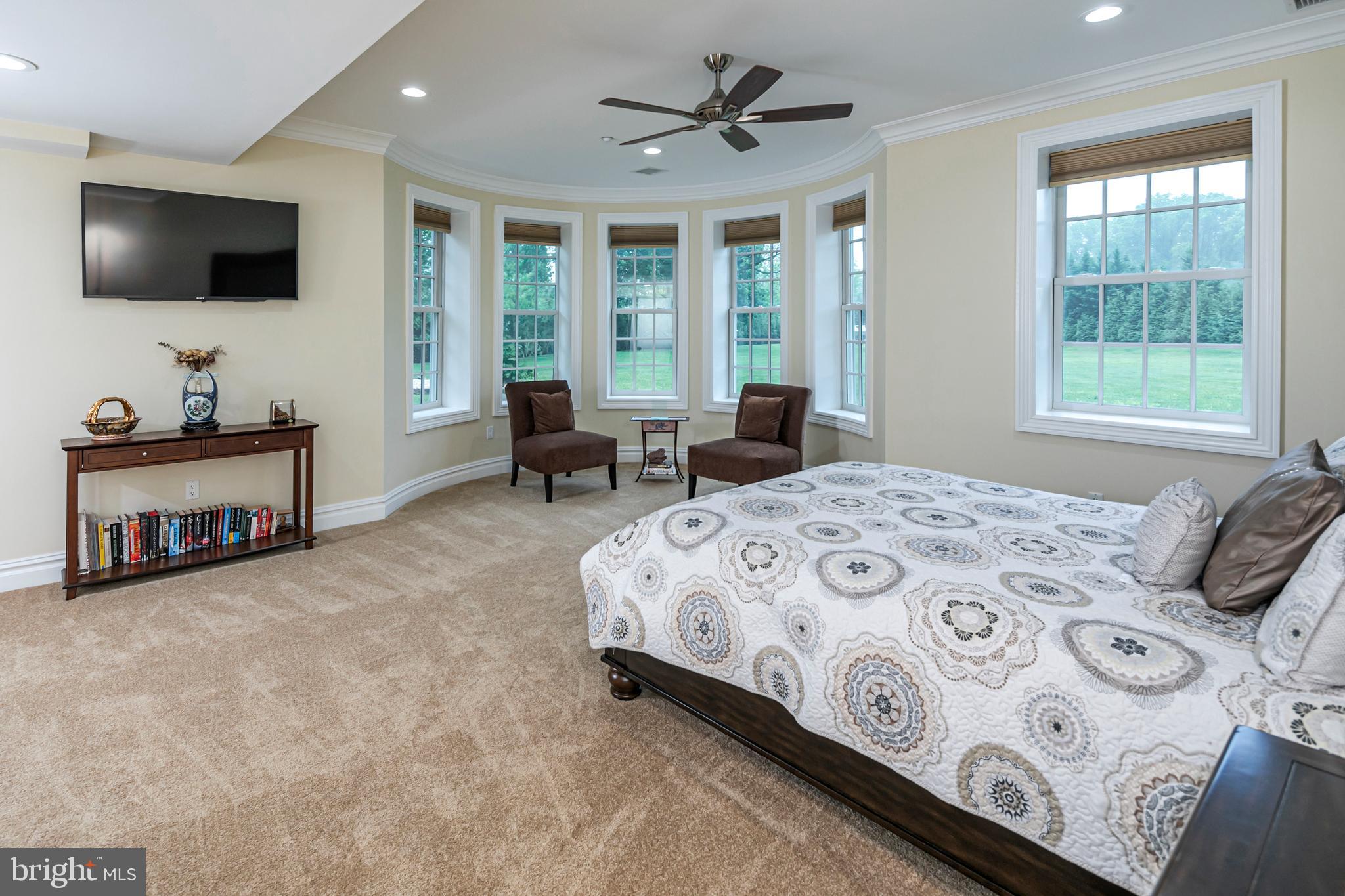 3870 Princeton Pike Lawrenceville, NJ 08648 - Photo 48 of 57 a spacious bedroom with a bed and a flat screen tv