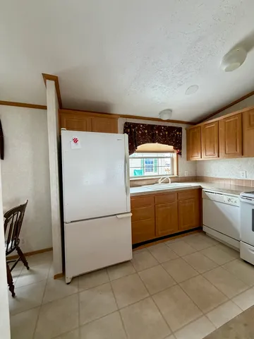 a kitchen with cabinets and white stainless steel appliances