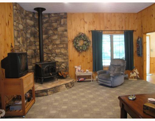 133 County Line Road Harrisville, PA 16038 - Photo 7 of 15 Living Room. Living room contains woodburner with stone surround