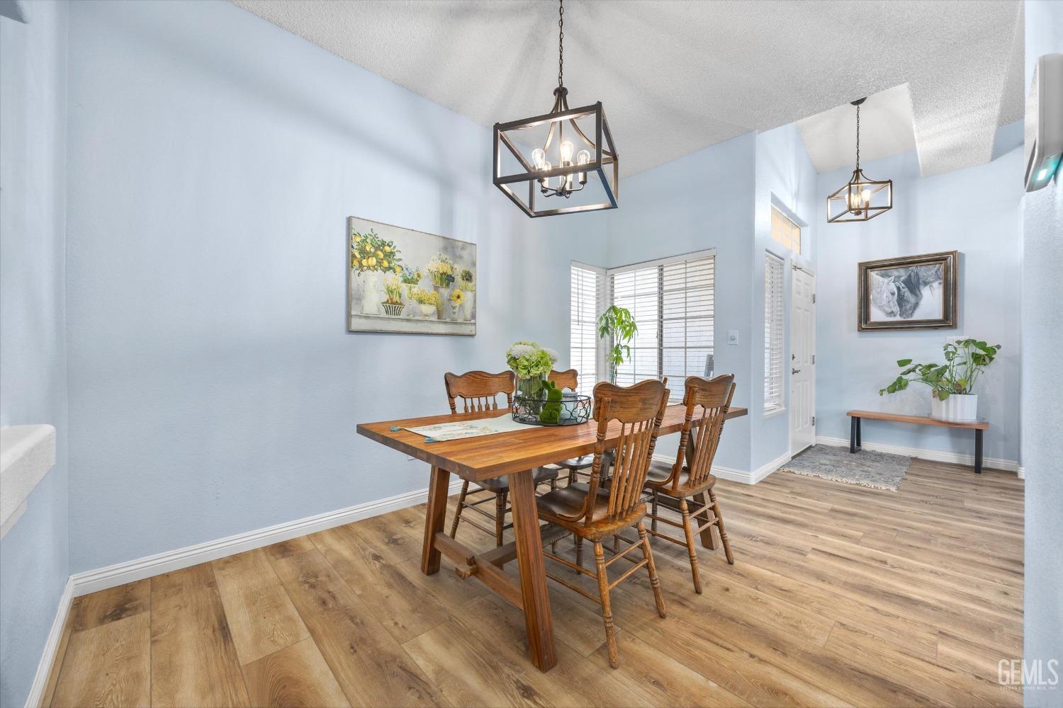 Undisclosed Address Bakersfield, CA 93312 - Photo 11 of 31 a view of a dining room with furniture and wooden floor