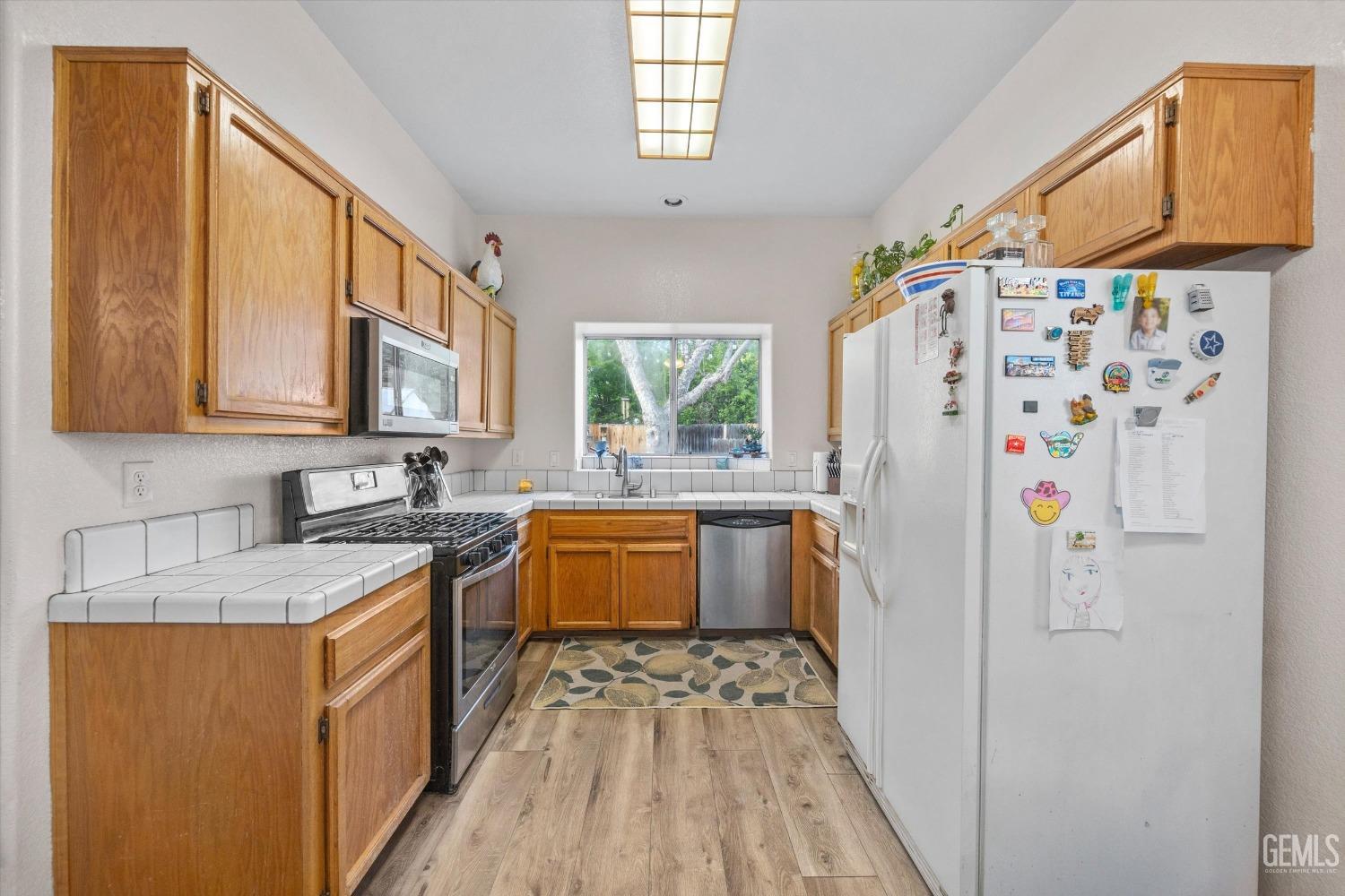 Undisclosed Address Bakersfield, CA 93312 - Photo 15 of 31 a kitchen with stainless steel appliances granite countertop a sink stove and refrigerator