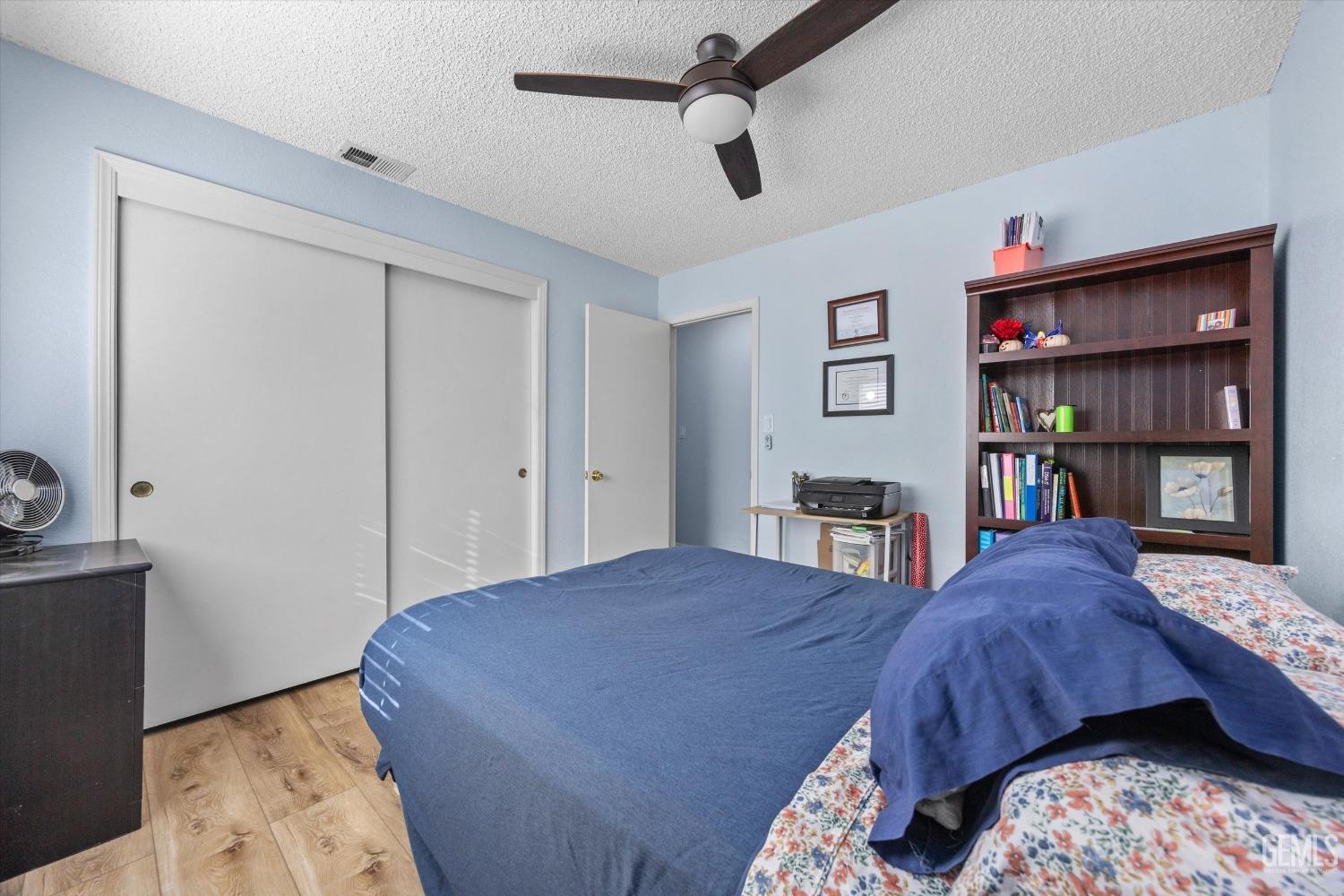 Undisclosed Address Bakersfield, CA 93312 - Photo 23 of 31 a bedroom with a bed and a book shelf