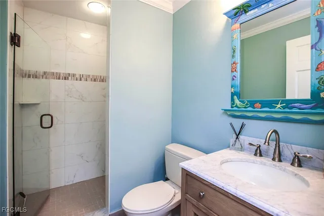 a bathroom with a granite countertop sink toilet a mirror and shower