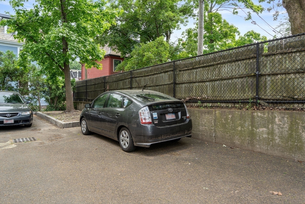 104 Harvard Street, Unit 6 Brookline, MA 02446 - Photo 17 of 18 a view of a car in a parking lot