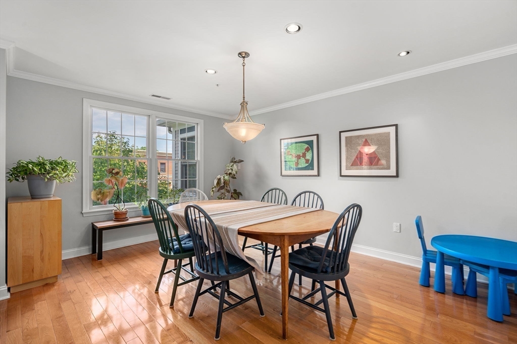104 Harvard Street, Unit 6 Brookline, MA 02446 - Photo 4 of 18 a view of a dining room with furniture window and wooden floor