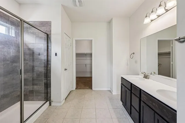 a bathroom with a shower and a sink