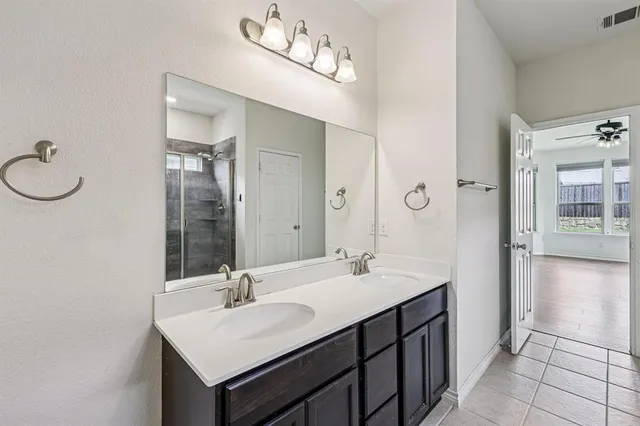 a bathroom with a sink vanity and a mirror
