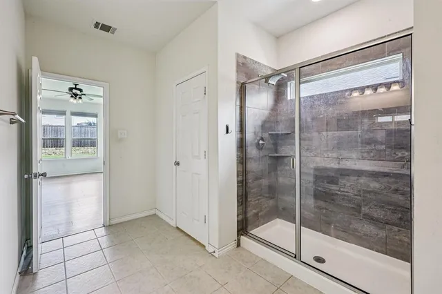 a bathroom with a glass shower door