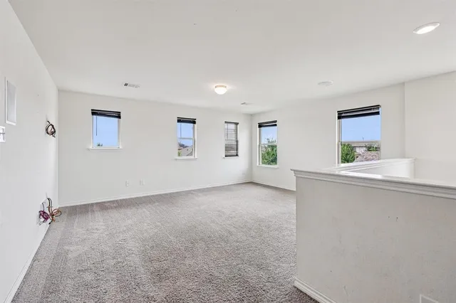 a view of a big room with windows and cabinet