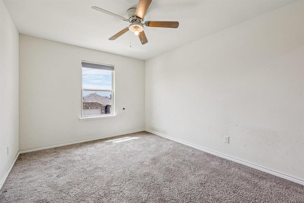 2712 Ryder Lane Aubrey, TX 76227 - Photo 21 of 26 an empty room with windows and fan