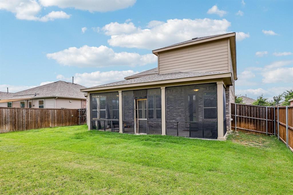 2712 Ryder Lane Aubrey, TX 76227 - Photo 23 of 26 a view of a house with a yard and wooden fence