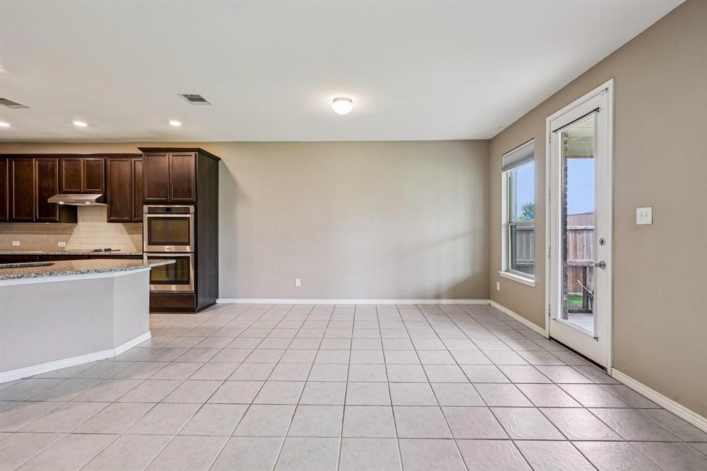 2712 Ryder Lane Aubrey, TX 76227 - Photo 3 of 26 a view of kitchen with cabinets and refrigerator