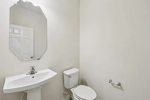 a white toilet sitting next to a bathroom sink