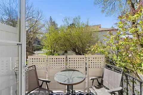 a view of a chairs and table in backyard