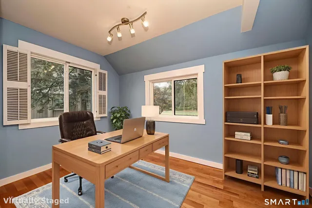 a view of a workspace with furniture and a potted plant
