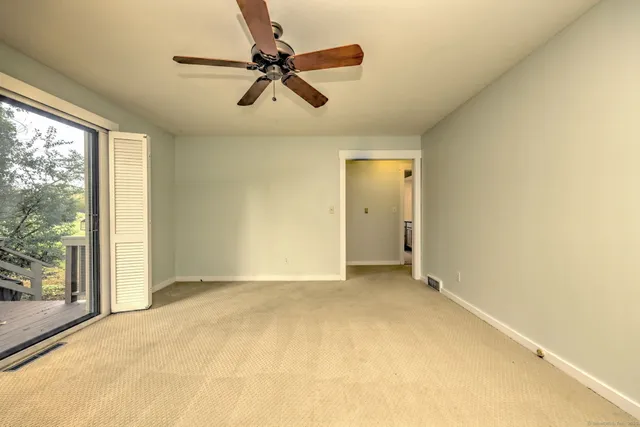 a view of room with a ceiling fan and window