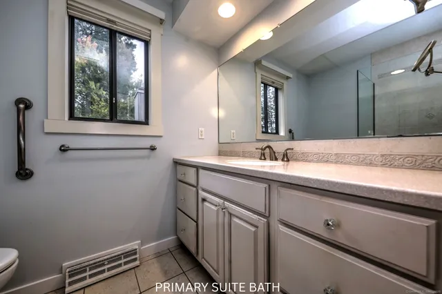 a bathroom with a sink a mirror and a toilet