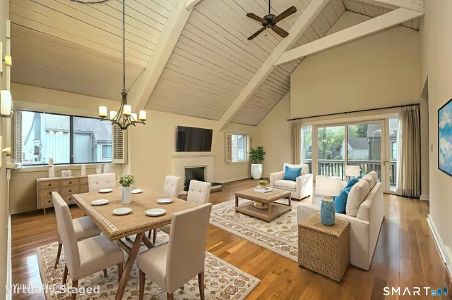 a living room with furniture a chandelier and a table