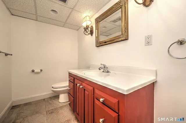 a view of a house with brick walls and a yard with plants