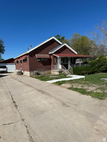 8320 West 3100th Street South Magna, UT 84044 - Photo 2 of 41 View of front of home with a porch and a garage