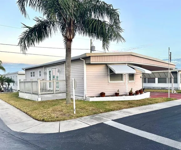 a view of a house with swimming pool and sitting area