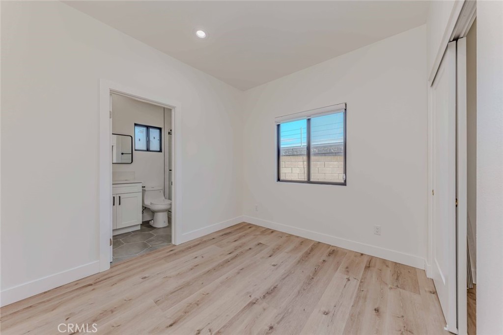 5825 View Circle Huntington Beach, CA 92649 - Photo 12 of 28 an empty room with wooden floor and a window