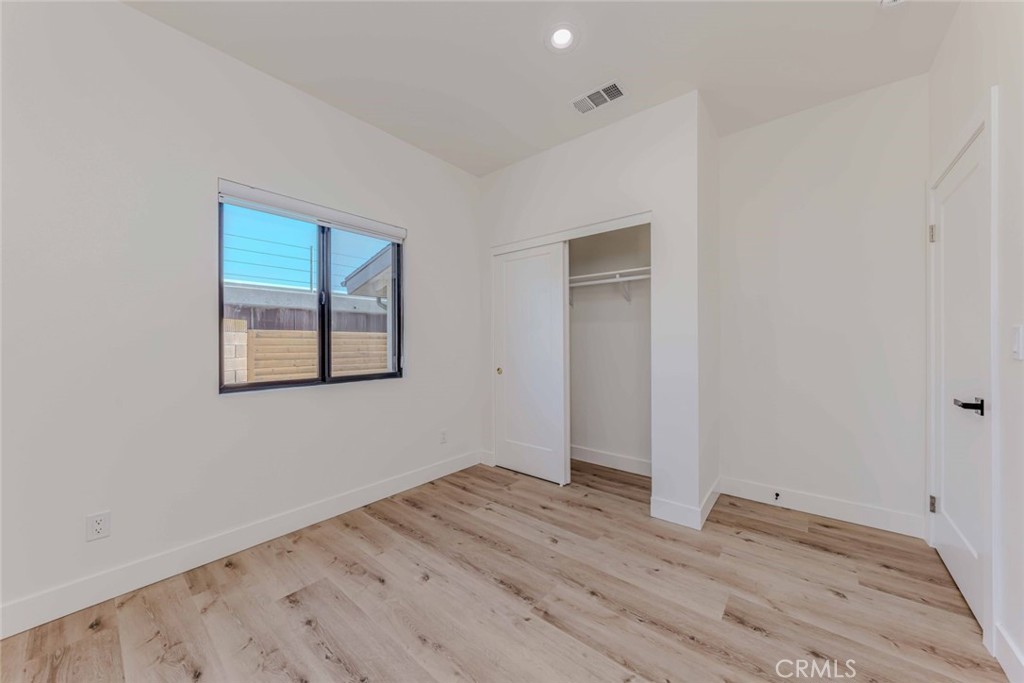 5825 View Circle Huntington Beach, CA 92649 - Photo 13 of 28 an empty room with wooden floor and windows