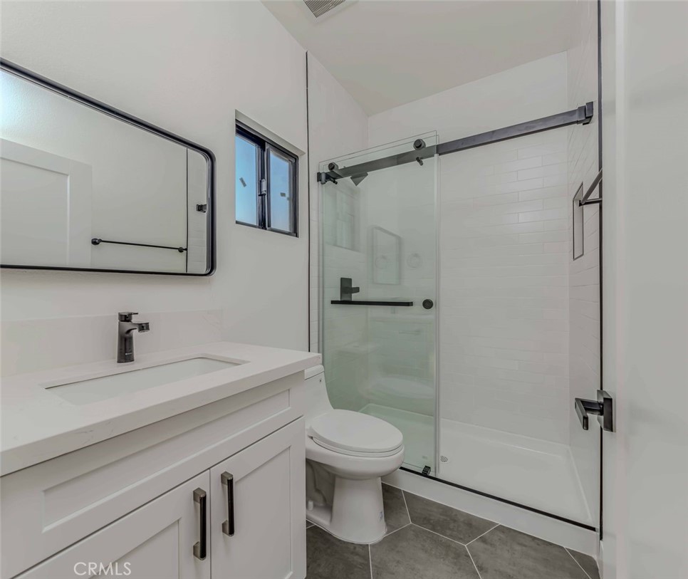 5825 View Circle Huntington Beach, CA 92649 - Photo 19 of 28 a bathroom with a sink a toilet and a shower