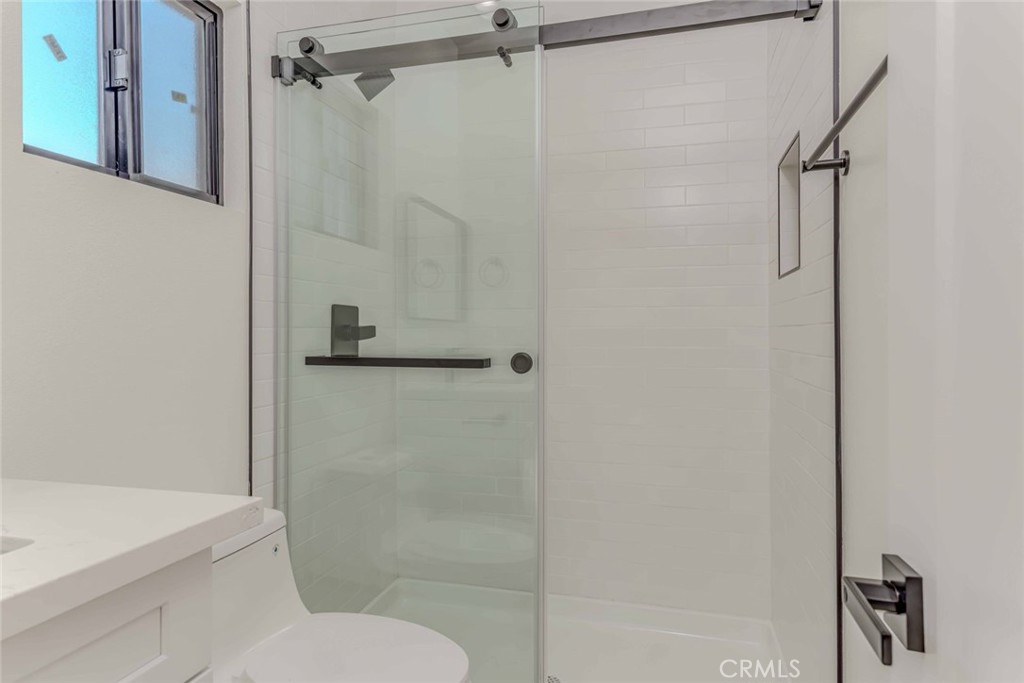 5825 View Circle Huntington Beach, CA 92649 - Photo 20 of 28 a bathroom with a shower and toilet