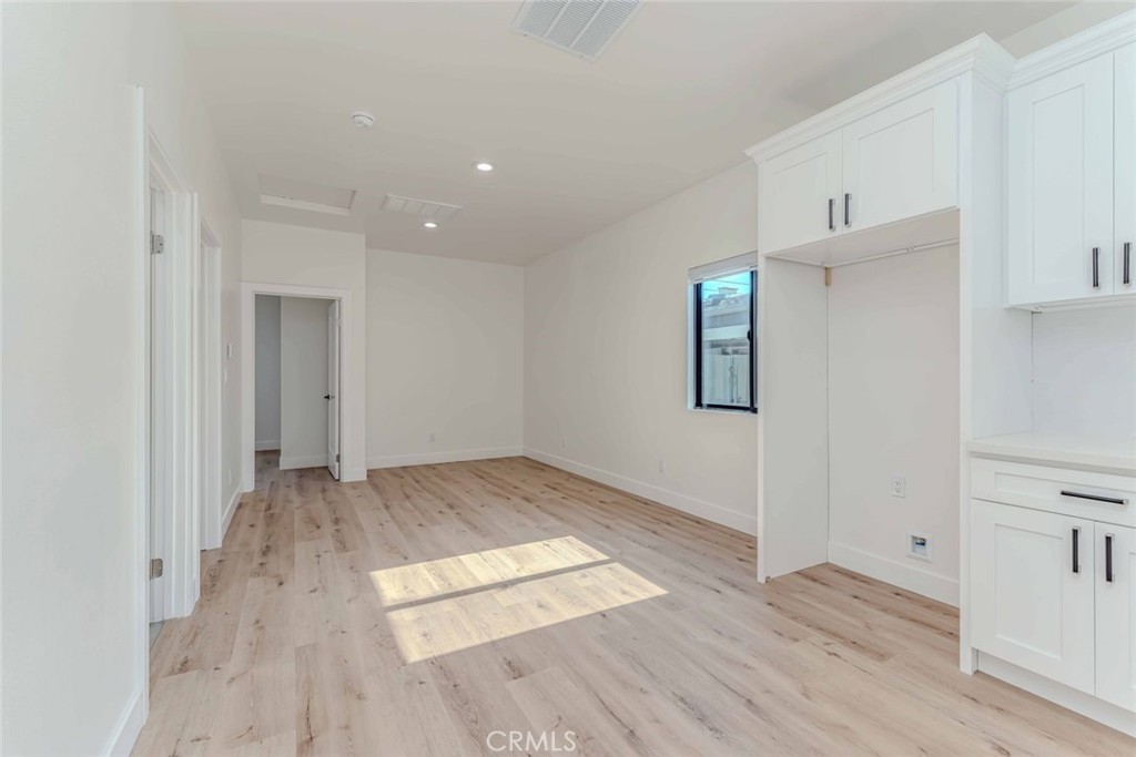 5825 View Circle Huntington Beach, CA 92649 - Photo 7 of 28 an empty room with wooden floor and closet