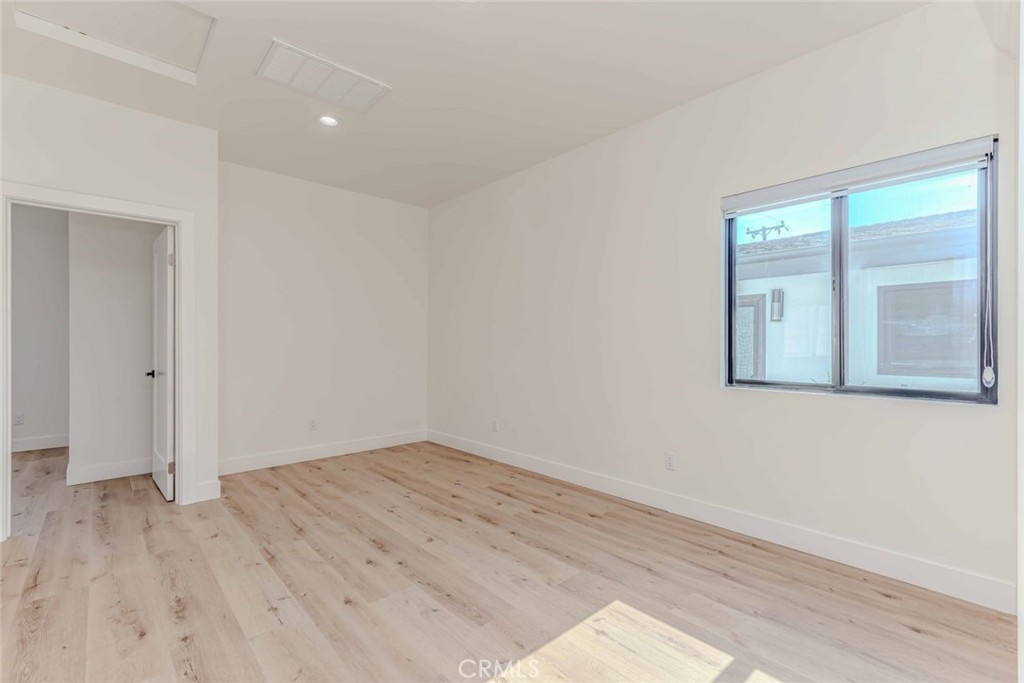 5825 View Circle Huntington Beach, CA 92649 - Photo 8 of 28 an empty room with wooden floor and windows