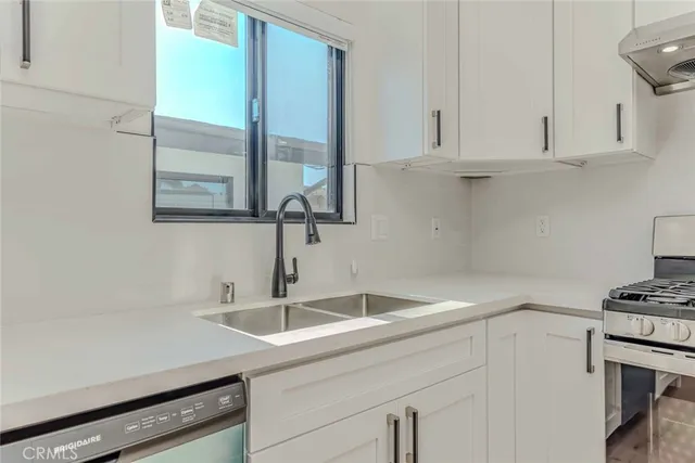 an empty room with wooden floor and a window