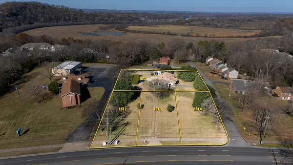 an aerial view of a house with yard swimming pool and outdoor seating