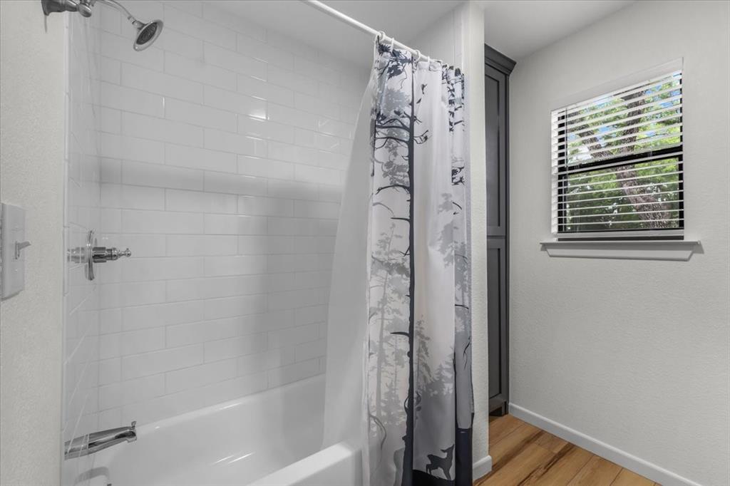 304 County Road 340 Ranger, TX 76470 - Photo 11 of 30 Bathtub and shower combination featuring white subway tile surround and chrome fixtures