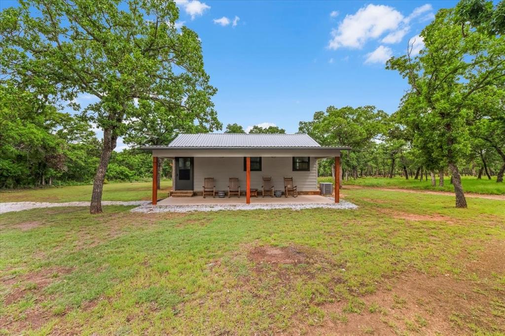 304 County Road 340 Ranger, TX 76470 - Photo 12 of 30 Light gray siding exterior with a dark gray metal roof