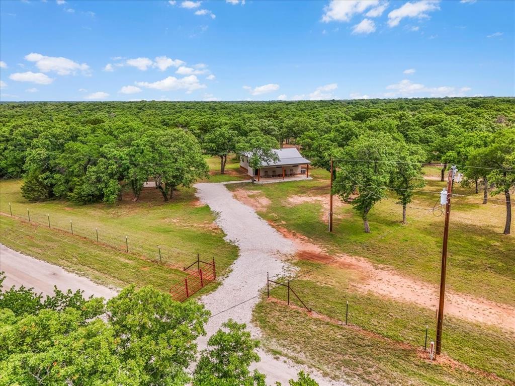 304 County Road 340 Ranger, TX 76470 - Photo 15 of 30 Expansive rural property featuring a gravel driveway and a fenced perimeter
