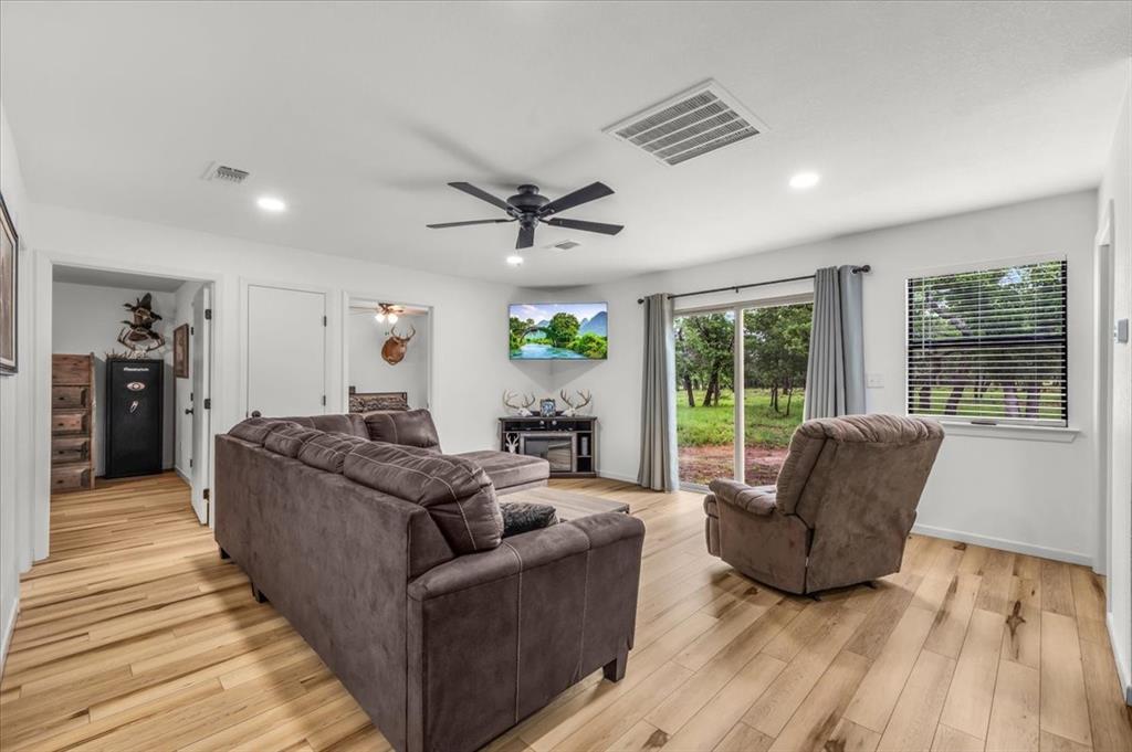 304 County Road 340 Ranger, TX 76470 - Photo 6 of 30 Spacious living area featuring wood-finish flooring, recessed lighting, and a ceiling fan
