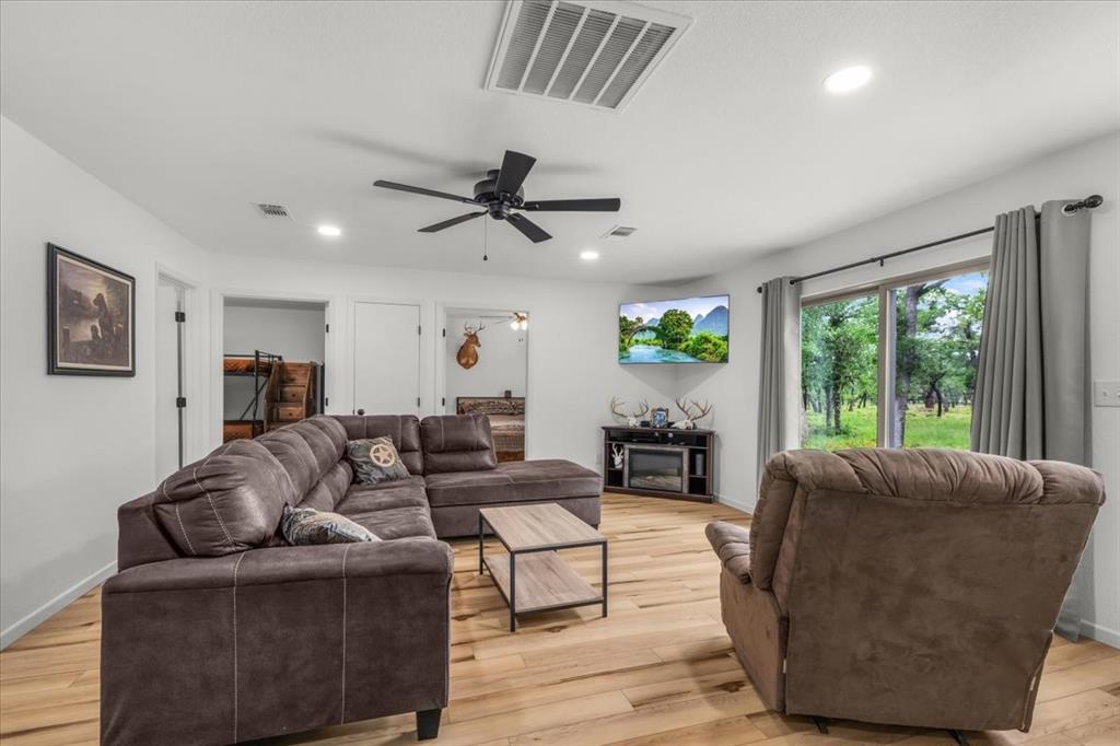 304 County Road 340 Ranger, TX 76470 - Photo 7 of 30 Spacious room featuring wood-finish flooring, recessed lighting, and a modern ceiling fan