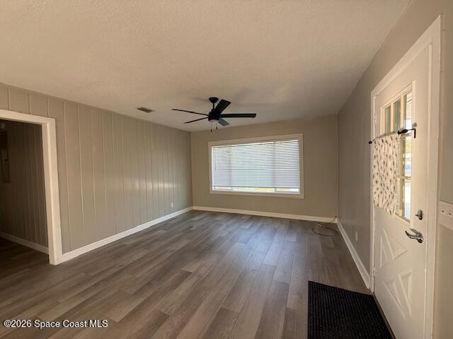 1925 Buffalo Road Titusville, FL 32796 - Photo 3 of 13 an empty room with wooden floor cabinet and windows