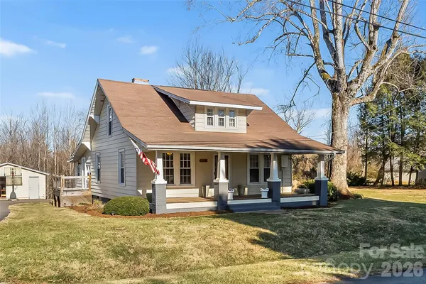 a view of a house with backyard porch and sitting area