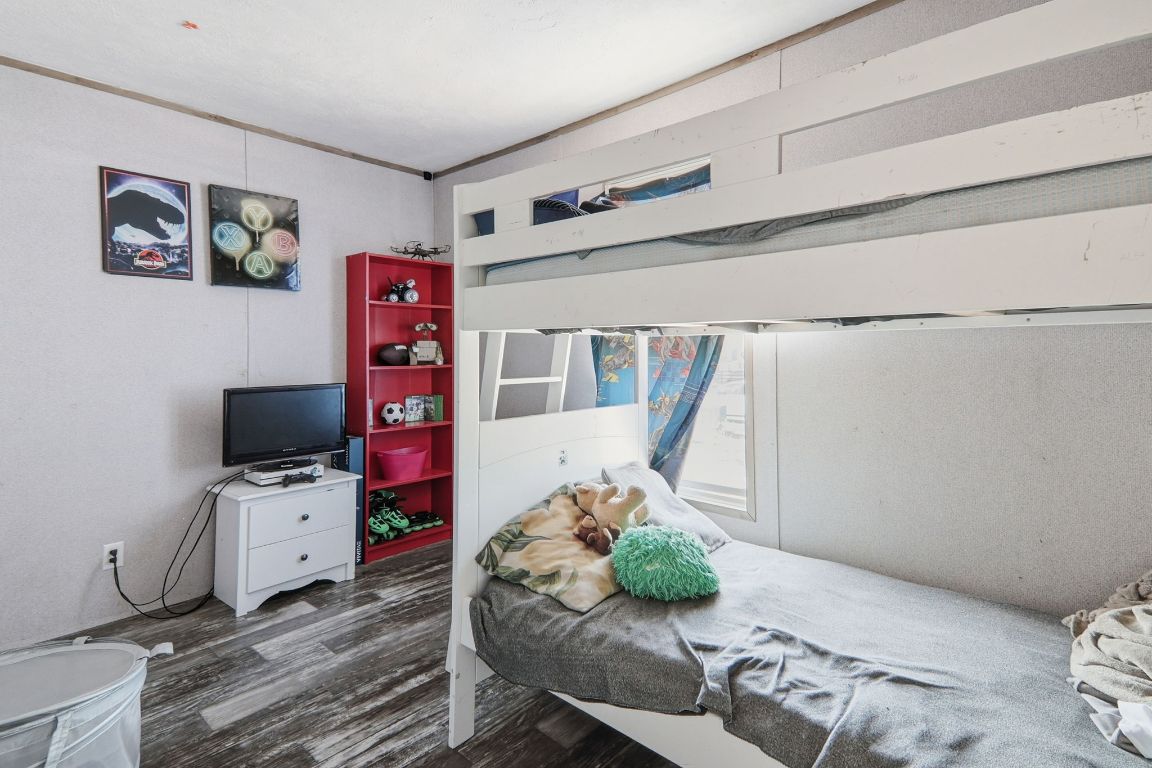 1130 Rustler Pass Kyle, TX 78640 - Photo 11 of 21 Bedroom with dark wood-type flooring
